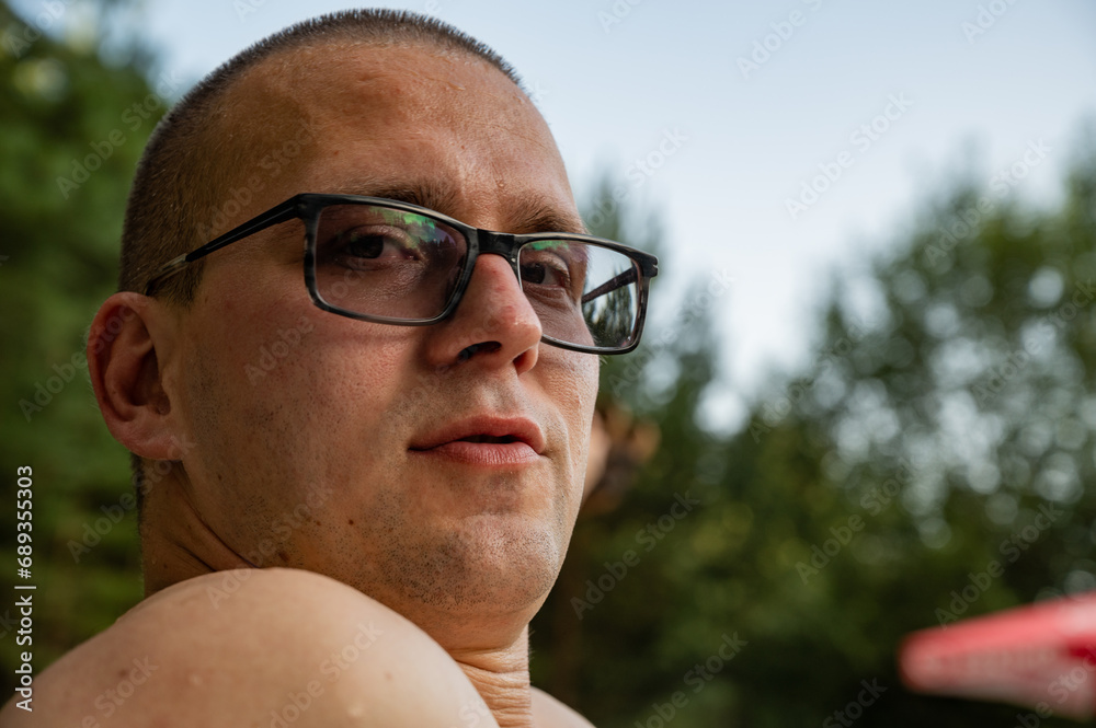Man in glasses with myopia outdoor Man in glasses with myopia outdoor