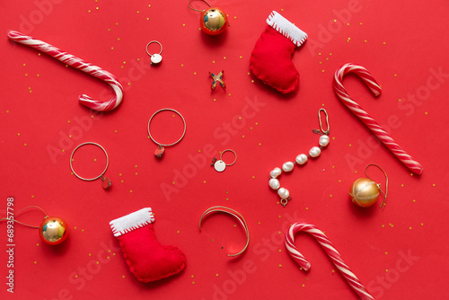 Christmas composition with jewelry and decor on red background