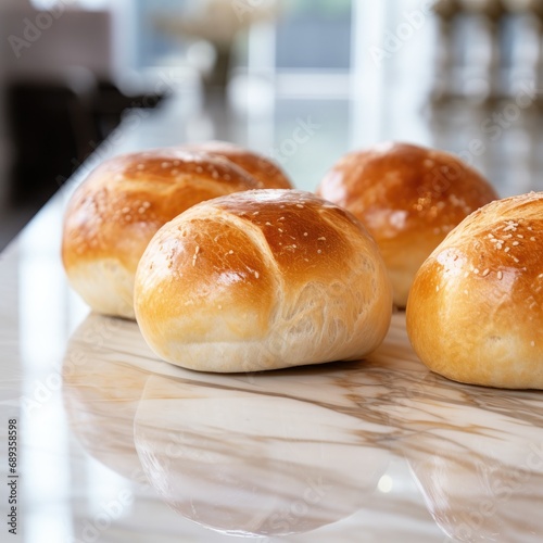 Delicious bread rolls on a marble counter top.