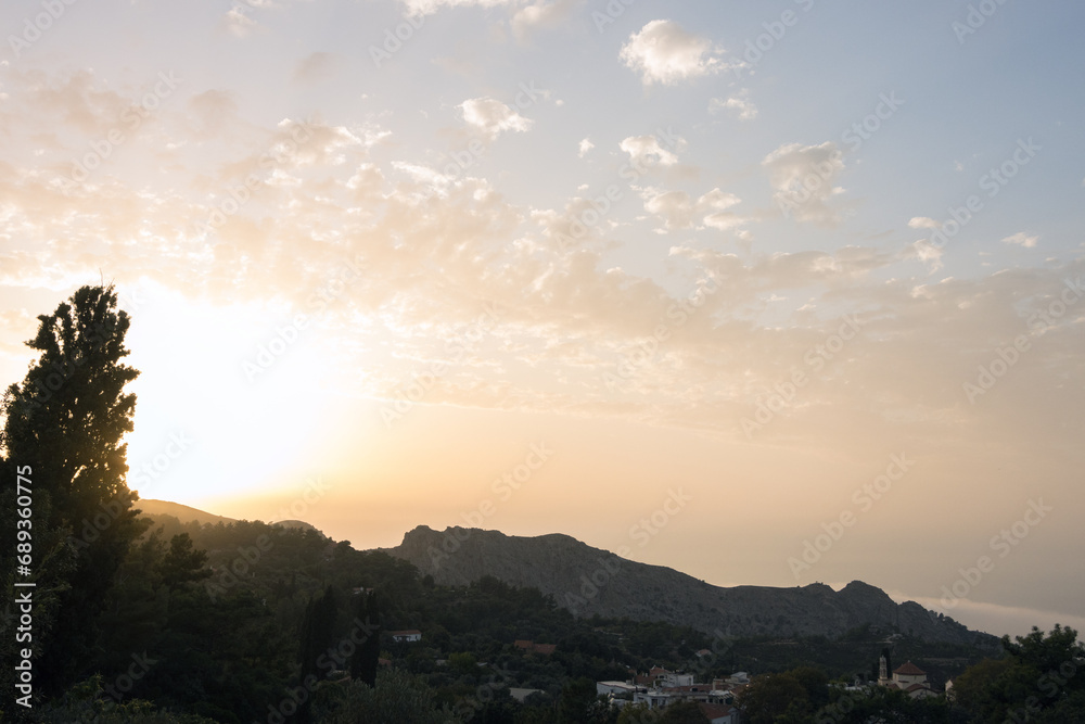 Gorgeous view to the mountain village of Christos Raches and the Halari canyon at sunset.