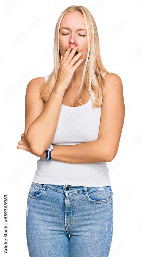 Young blonde girl wearing casual style with sleeveless shirt bored yawning tired covering mouth with hand. restless and sleepiness. Young blonde girl wearing casual style with sleeveless shirt bored yawning tired covering mouth with hand. restless and sleepiness.