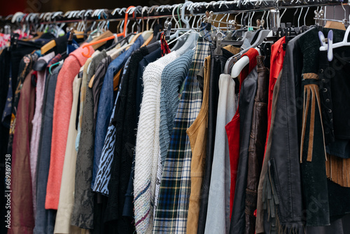 Rack with second hand clothes at flea market.