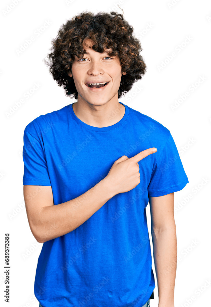 Caucasian teenager pointing with fingers to the side smiling and laughing hard out loud because funny crazy joke. Caucasian teenager pointing with fingers to the side smiling and laughing hard out loud because funny crazy joke.
