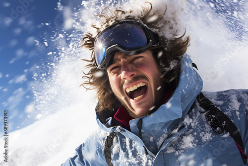 Thrilled snowboarder with goggles enjoys the mountain snow.