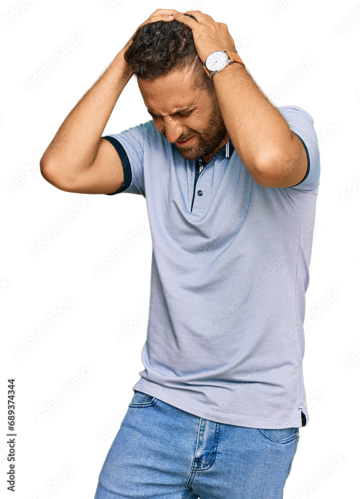 Handsome man with beard wearing casual clothes suffering from headache desperate and stressed because pain and migraine. hands on head. Handsome man with beard wearing casual clothes suffering from headache desperate and stressed because pain and migraine. hands on head.