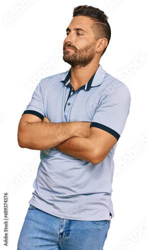 Handsome man with beard wearing casual clothes looking to the side with arms crossed convinced and confident