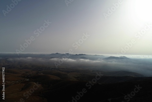 the mountain range is covered in many clouds and mountains are visible