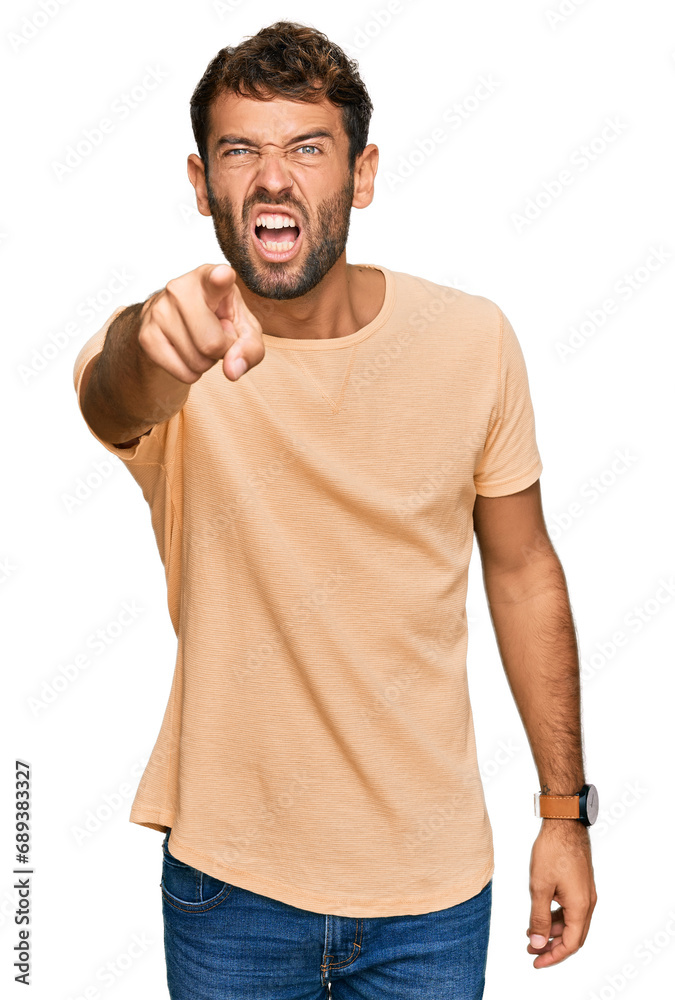 Handsome young man with beard wearing casual tshirt pointing displeased and frustrated to the camera, angry and furious with you Handsome young man with beard wearing casual tshirt pointing displeased and frustrated to the camera, angry and furious with you