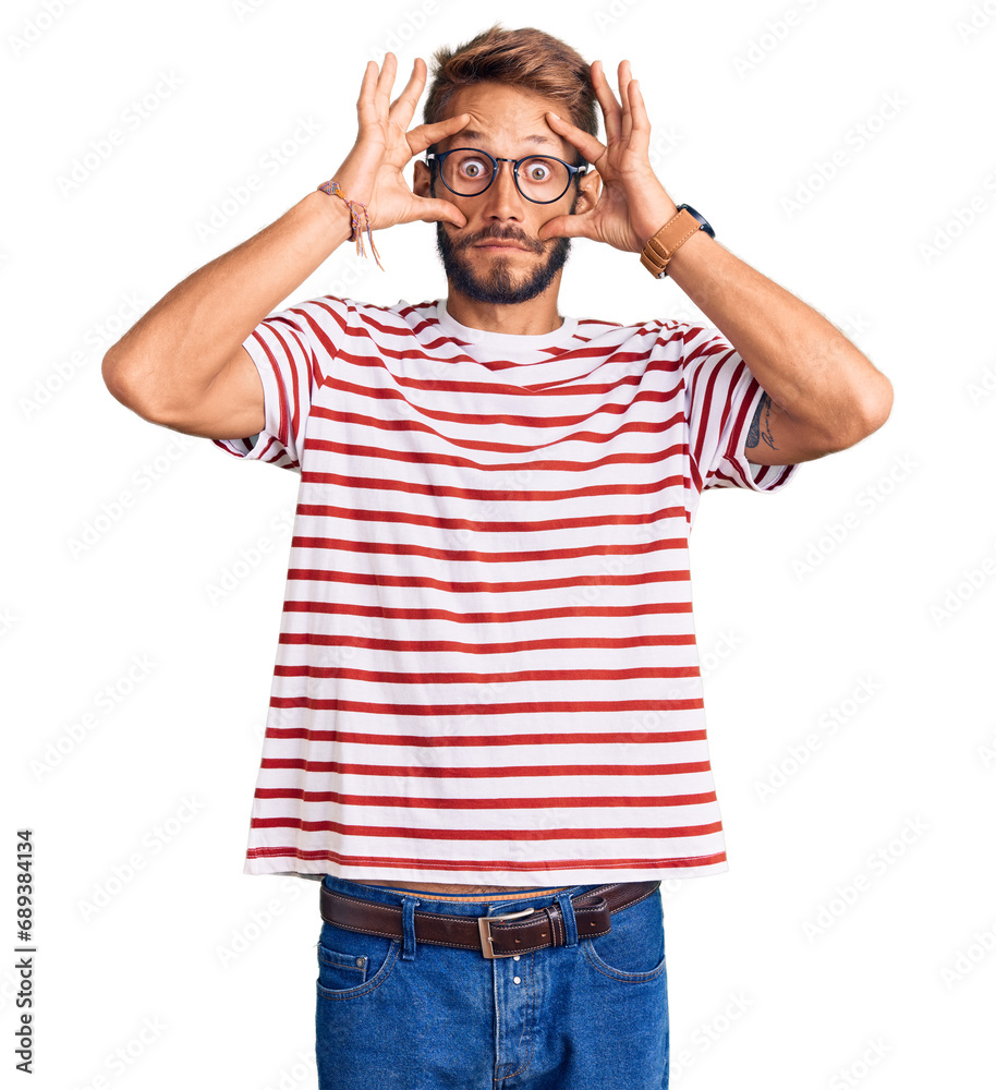 Handsome blond man with beard wearing casual clothes and glasses trying to open eyes with fingers, sleepy and tired for morning fatigue Handsome blond man with beard wearing casual clothes and glasses trying to open eyes with fingers, sleepy and tired for morning fatigue