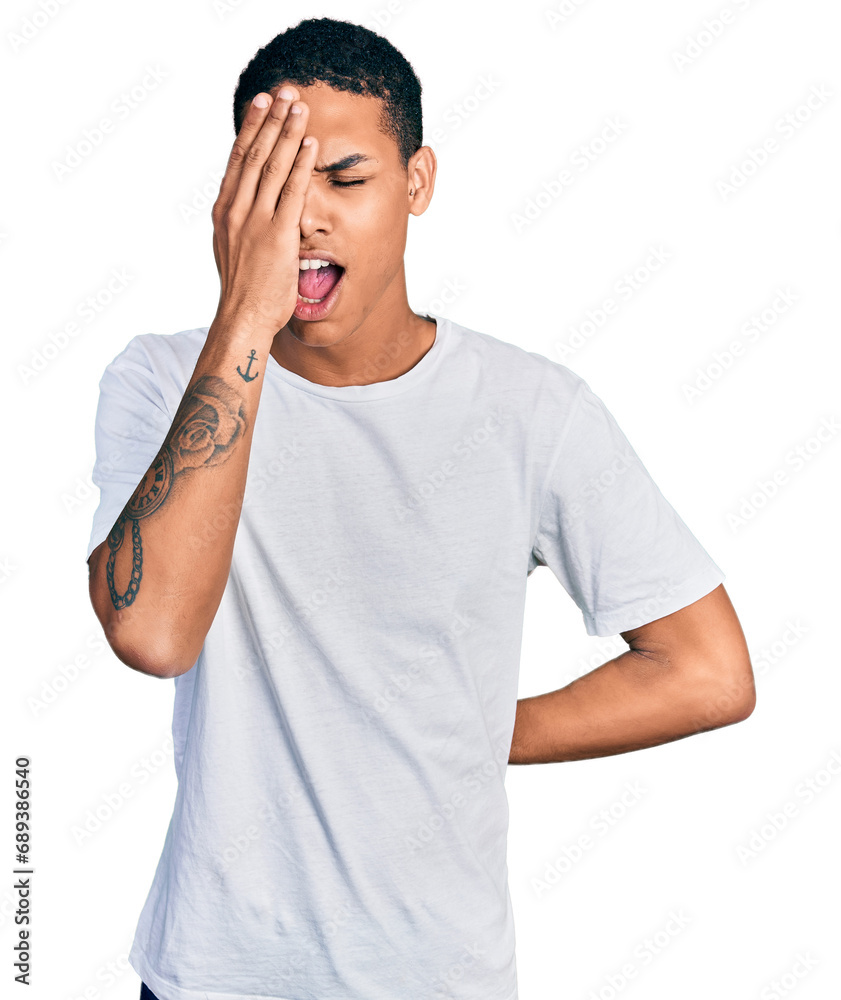 Young hispanic man wearing casual white t shirt yawning tired covering half face, eye and mouth with hand. face hurts in pain. Young hispanic man wearing casual white t shirt yawning tired covering half face, eye and mouth with hand. face hurts in pain.