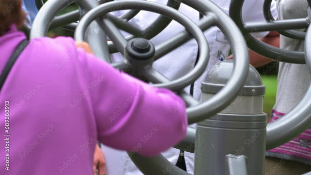 Senior people exercising at the outdoor gym with the help of a caregiver. High quality 4k video. Senior people exercising at the outdoor gym with the help of a caregiver. High quality 4k video.