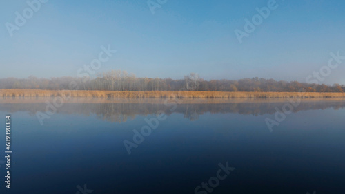 Morning on the river. Nature. Autumn. Reflection of trees in the water