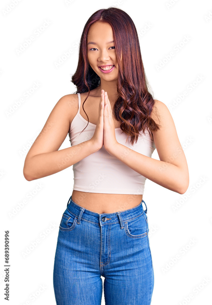 Young beautiful chinese girl wearing casual clothes praying with hands together asking for forgiveness smiling confident. Young beautiful chinese girl wearing casual clothes praying with hands together asking for forgiveness smiling confident.