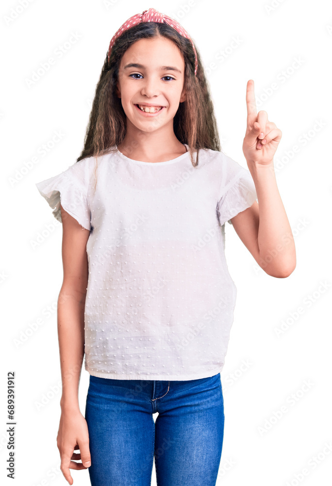 Cute hispanic child girl wearing casual white tshirt pointing finger up with successful idea. exited and happy. number one. Cute hispanic child girl wearing casual white tshirt pointing finger up with successful idea. exited and happy. number one.
