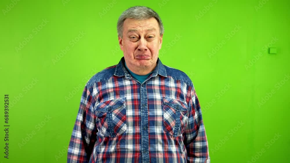 Senior smiling man sees something and gets very upset to point of cry. Senior smiling man sees something and gets very upset to point of cry.