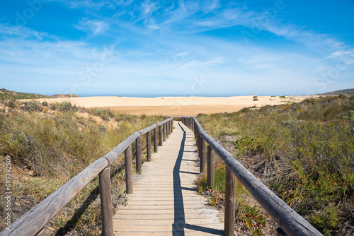 wooden boardwalk to the sandy beach, tourist resort Carrapateira Portugal