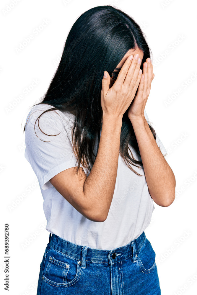 Young hispanic woman wearing casual clothes and glasses with sad expression covering face with hands while crying. depression concept. Young hispanic woman wearing casual clothes and glasses with sad expression covering face with hands while crying. depression concept.