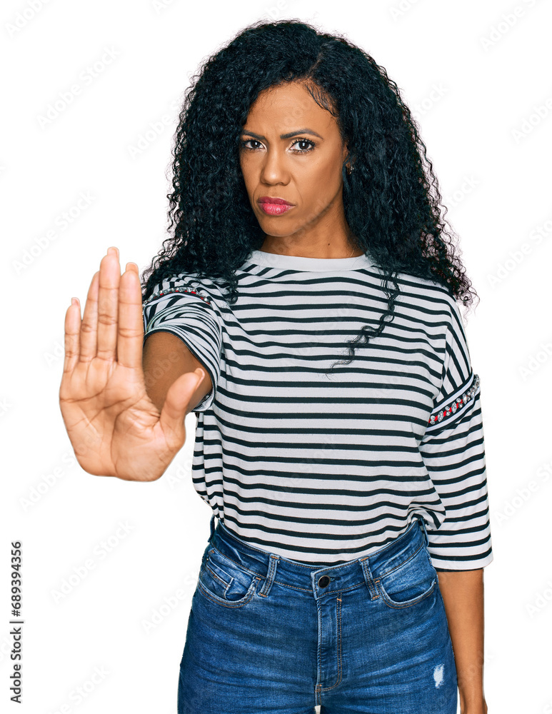 Middle age african american woman wearing casual clothes doing stop sing with palm of the hand. warning expression with negative and serious gesture on the face.