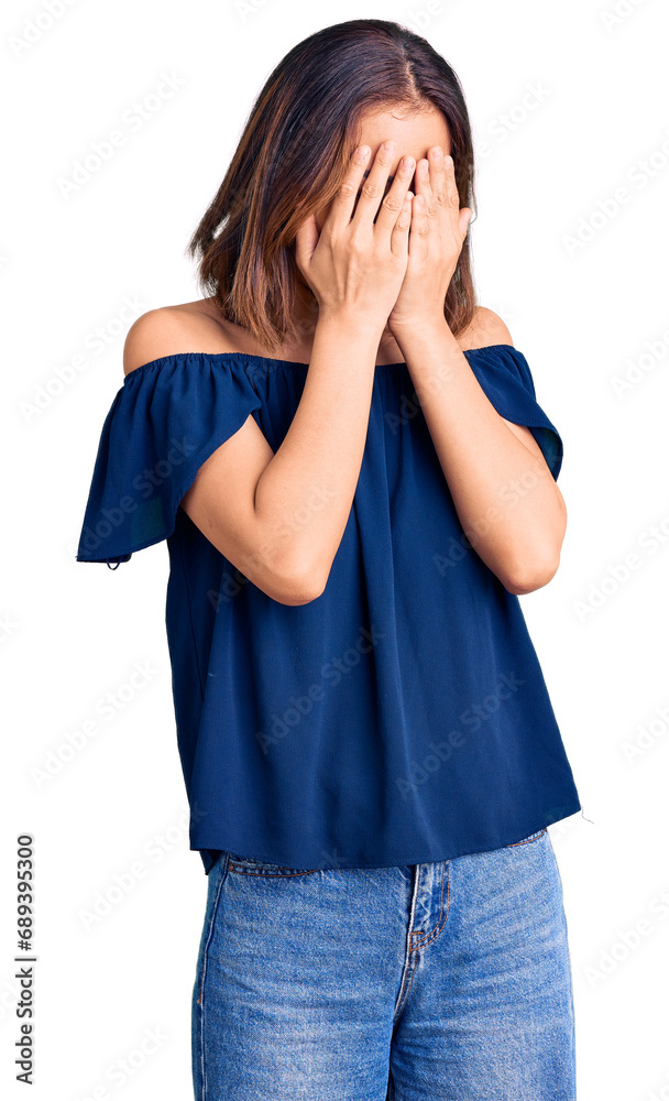 Young beautiful chinese girl wearing casual clothes with sad expression covering face with hands while crying. depression concept. Young beautiful chinese girl wearing casual clothes with sad expression covering face with hands while crying. depression concept.