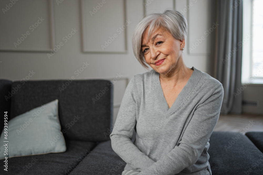 Portrait of confident stylish european middle aged senior woman. Older mature 60s lady smiling at home. Happy attractive senior female looking camera close up face headshot portrait. Happy people Portrait of confident stylish european middle aged senior woman. Older mature 60s lady smiling at home. Happy attractive senior female looking camera close up face headshot portrait. Happy people