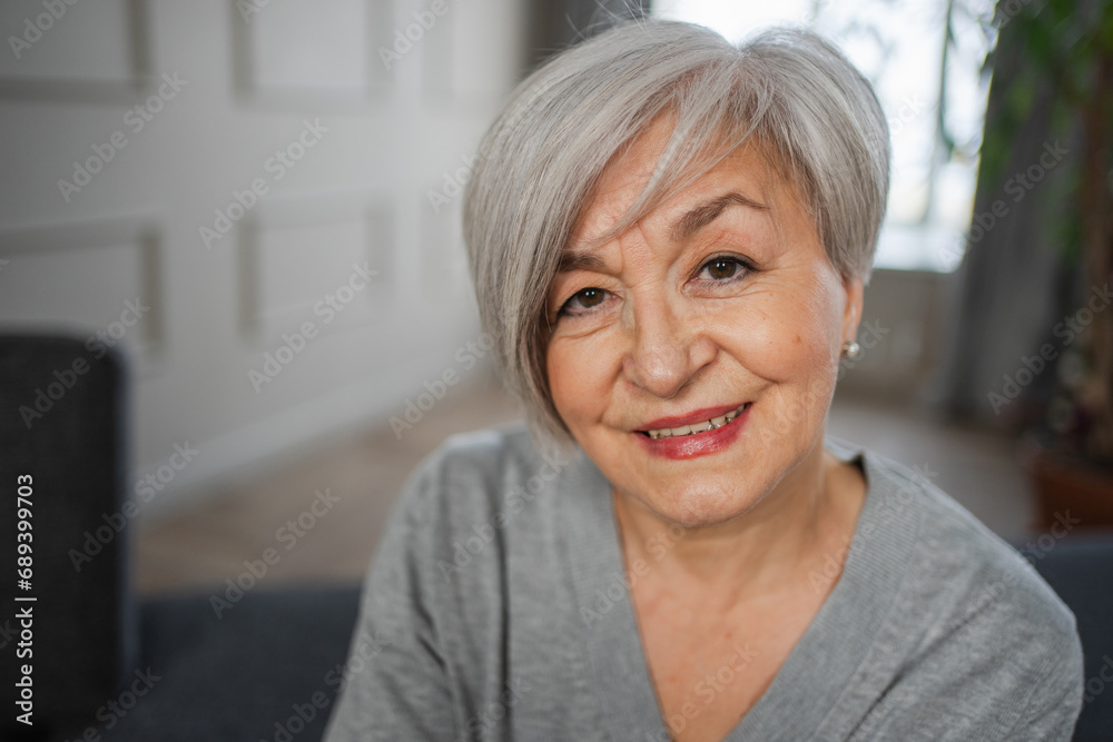 Portrait of confident stylish european middle aged senior woman. Older mature 60s lady smiling at home. Happy attractive senior female looking camera close up face headshot portrait. Happy people Portrait of confident stylish european middle aged senior woman. Older mature 60s lady smiling at home. Happy attractive senior female looking camera close up face headshot portrait. Happy people