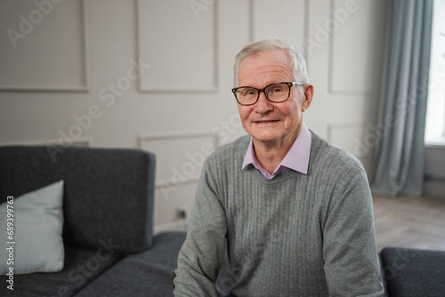 Portrait of confident stylish European middle aged senior man at home. Older mature 70s man smiling. Happy attractive senior grandfather looking camera close up face headshot portrait. Happy people © Юлия Завалишина