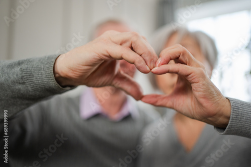 Love heart shape peace. Senior older couple making heart shape with their hands. Adult mature old husband wife showing heart sign. Happy pensioner family. I love you happy valentines day