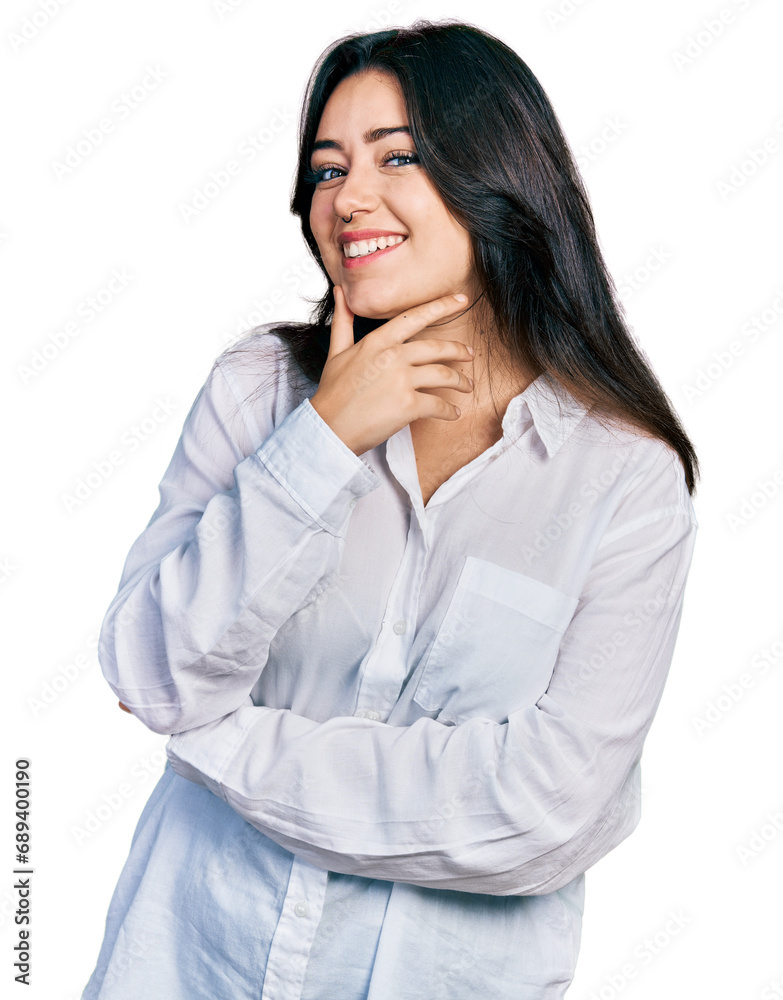 Beautiful hispanic woman wearing casual white shirt looking confident at the camera smiling with crossed arms and hand raised on chin. thinking positive. Beautiful hispanic woman wearing casual white shirt looking confident at the camera smiling with crossed arms and hand raised on chin. thinking positive.