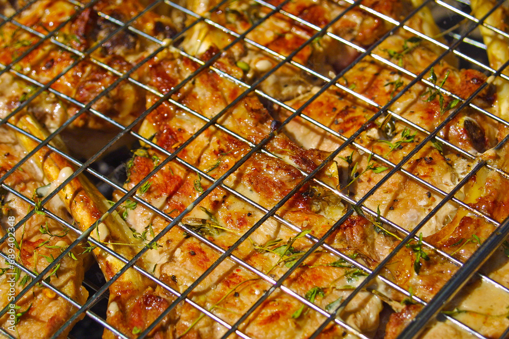 Close-up beef steak cooking on a grill with spices