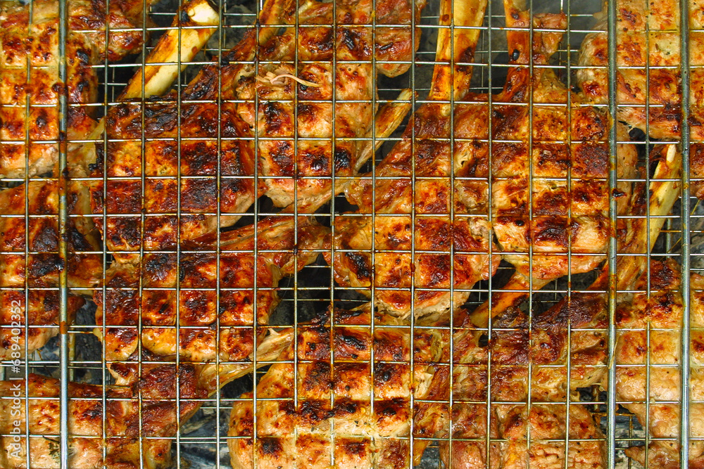 Close-up beef steaks cooking on a grill with spices