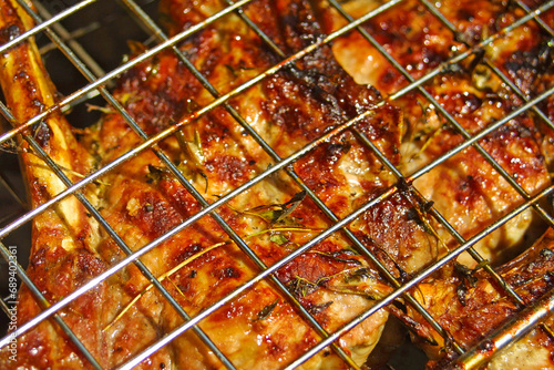 Obraz na płótnie Close-up beef steak cooking on a grill with spices w salonie