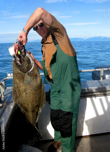 Man catching Halibut in Alaskan Waters.