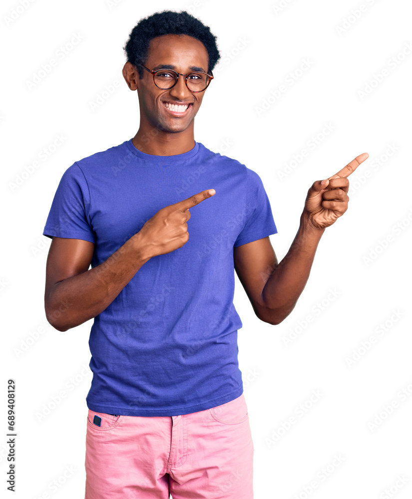 African handsome man wearing casual clothes and glasses smiling and looking at the camera pointing with two hands and fingers to the side. African handsome man wearing casual clothes and glasses smiling and looking at the camera pointing with two hands and fingers to the side.