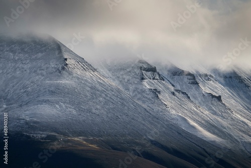 Fresh snow on mountain slopes, clouds, Isfjord, Spitsbergen Island, Spitsbergen archipelago, Svalbard, Norway, Europe photo