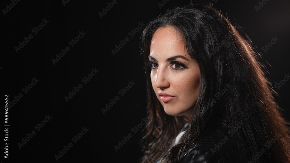 Young confident woman in a black studio environment - studio photography Young confident woman in a black studio environment - studio photography