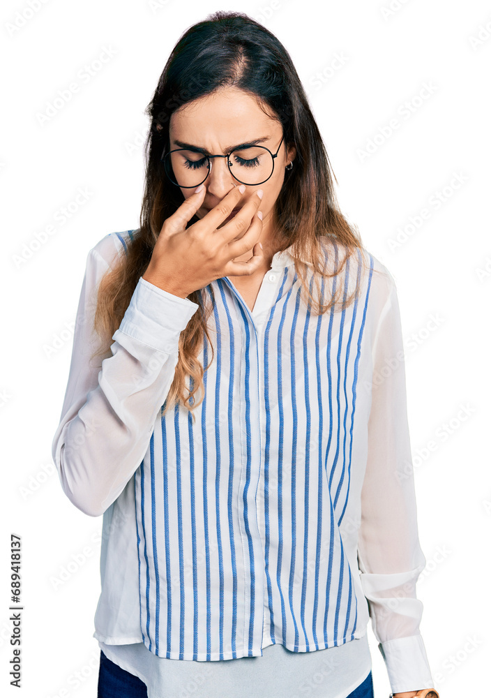 Beautiful hispanic woman wearing casual striped shirt tired rubbing nose and eyes feeling fatigue and headache. stress and frustration concept. Beautiful hispanic woman wearing casual striped shirt tired rubbing nose and eyes feeling fatigue and headache. stress and frustration concept.