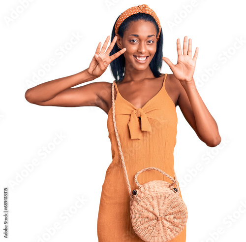 Young african american woman wearing summer outfit showing and pointing up with fingers number nine while smiling confident and happy. photo