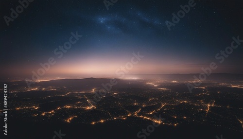 Aerial view of the night city with starry sky and Milky Way