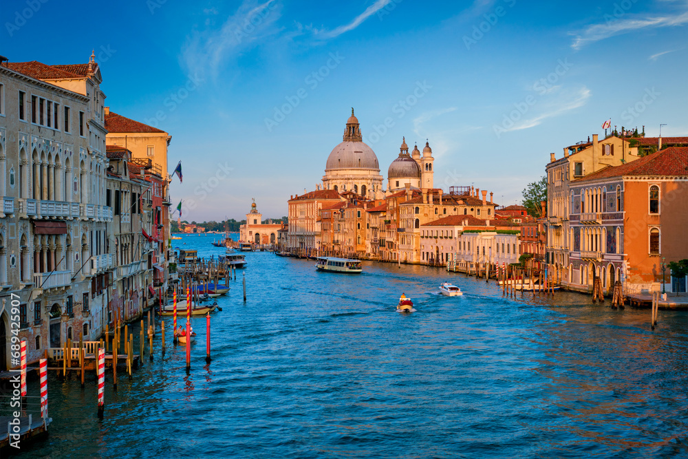 Panorama of Venice Grand Canal with boats and Santa Maria della Salute church on sunset from Ponte dell'Accademia bridge. Venice, Italy - obrazy, fototapety, plakaty 