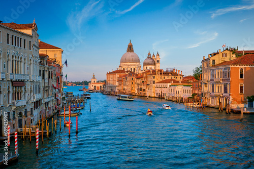 Panorama of Venice Grand Canal with boats and Santa Maria della Salute church on sunset from Ponte dell'Accademia bridge. Venice, Italy photo