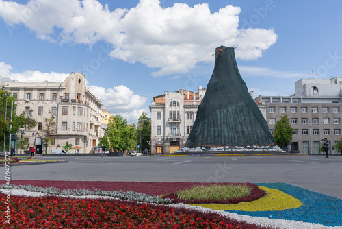 tall historical statue covered for protection in square of shevchenko park in kharkiv city photo
