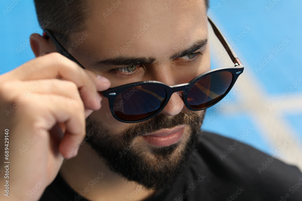 Handsome man in sunglasses outdoors on sunny day, closeup Handsome man in sunglasses outdoors on sunny day, closeup