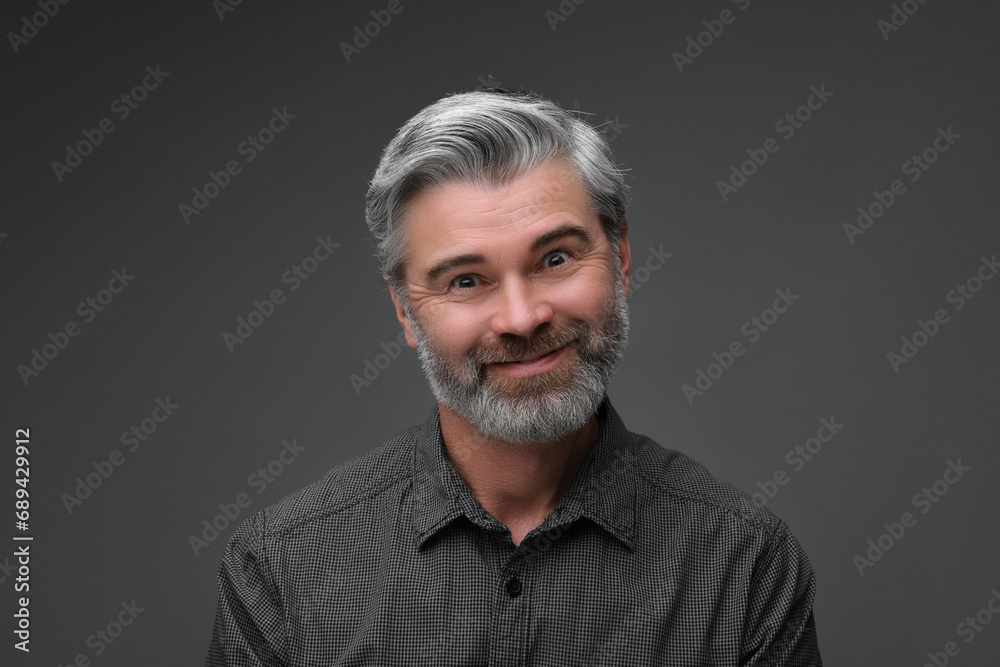 Personality concept. Portrait of bearded man on dark grey background Personality concept. Portrait of bearded man on dark grey background