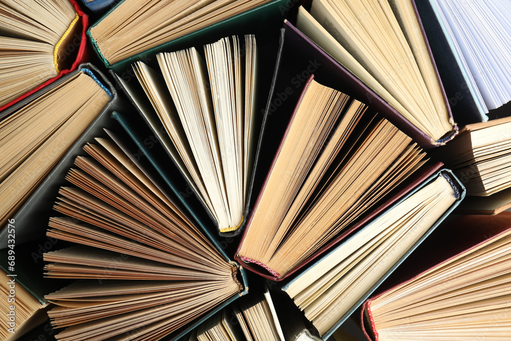 Naklejka premium Many different hardcover books on dark background, top view