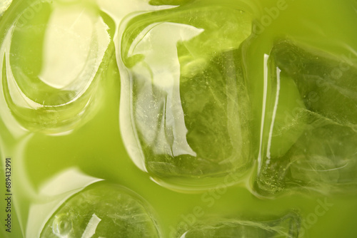 Delicious iced green matcha tea as background, closeup photo