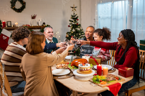 Multi-ethnic family celebrating Christmas party together in house. 