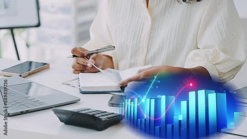 Mujer trabajando en su escritorio con su laptop y su móvil, toma nota, realiza anotaciones en su agenda, saca conclusiones, analiza datos. Un diagrama de barras en movimiento muestra evolución.