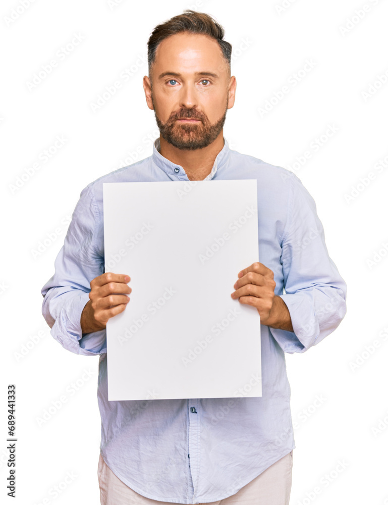 Handsome middle age man holding blank empty banner thinking attitude and sober expression looking self confident Handsome middle age man holding blank empty banner thinking attitude and sober expression looking self confident