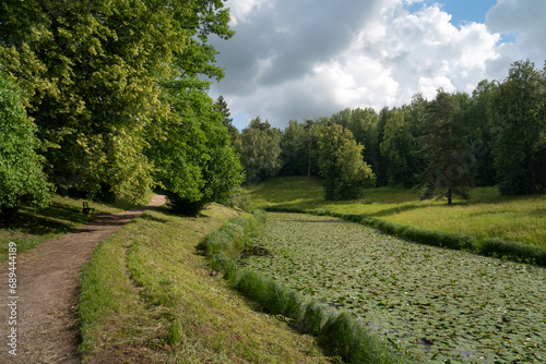 Slavyanka River Valley in the landscape part of the Pavlovsk Palace and Park Complex on a sunny summer day, Pavlovsk, Saint Petersburg, Russia © Ula Ulachka
