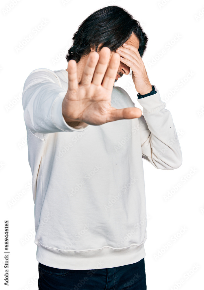Middle age caucasian man wearing casual clothes covering eyes with hands and doing stop gesture with sad and fear expression. embarrassed and negative concept. Middle age caucasian man wearing casual clothes covering eyes with hands and doing stop gesture with sad and fear expression. embarrassed and negative concept.